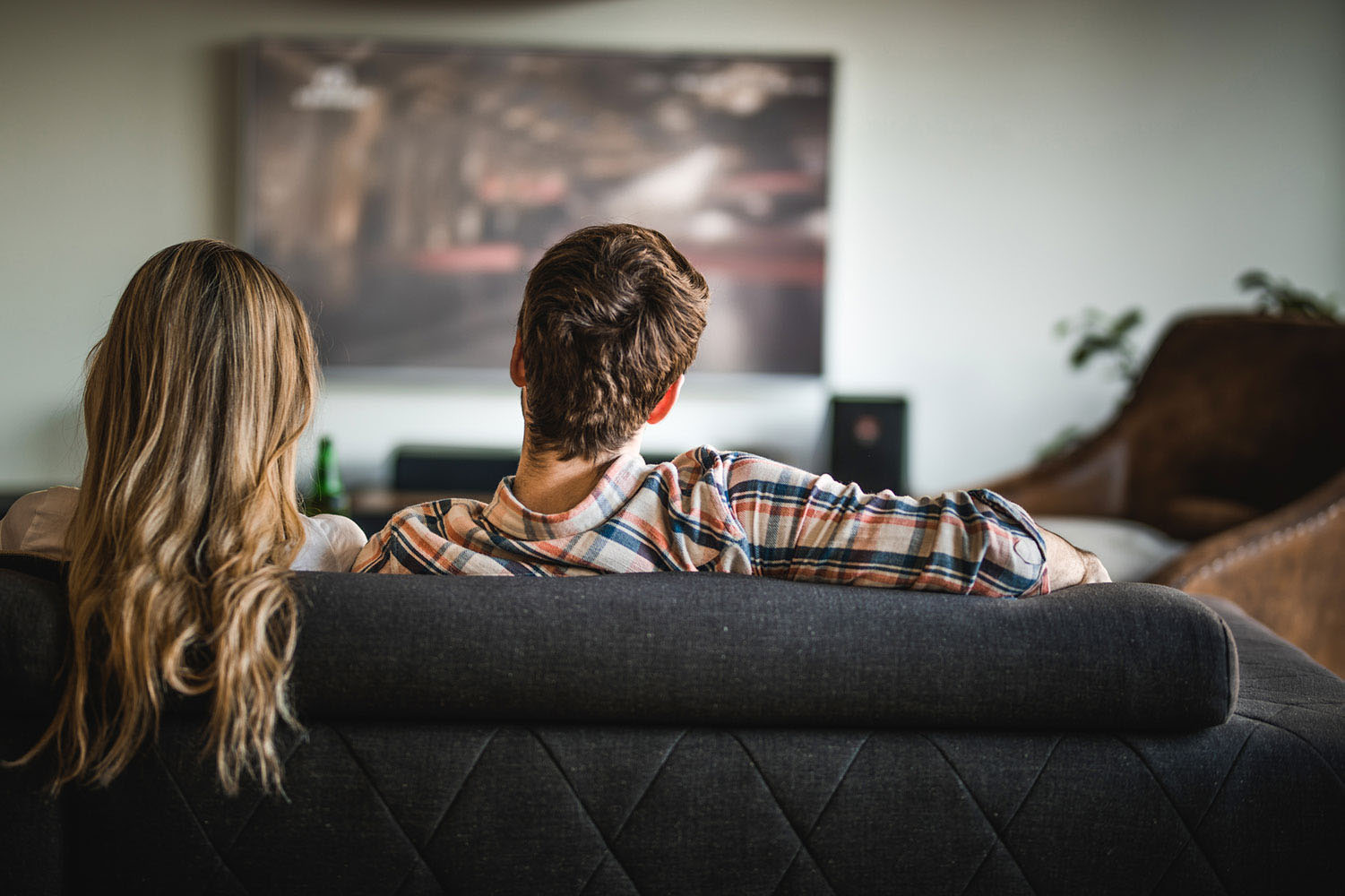 Couple sitting on couch watching TV