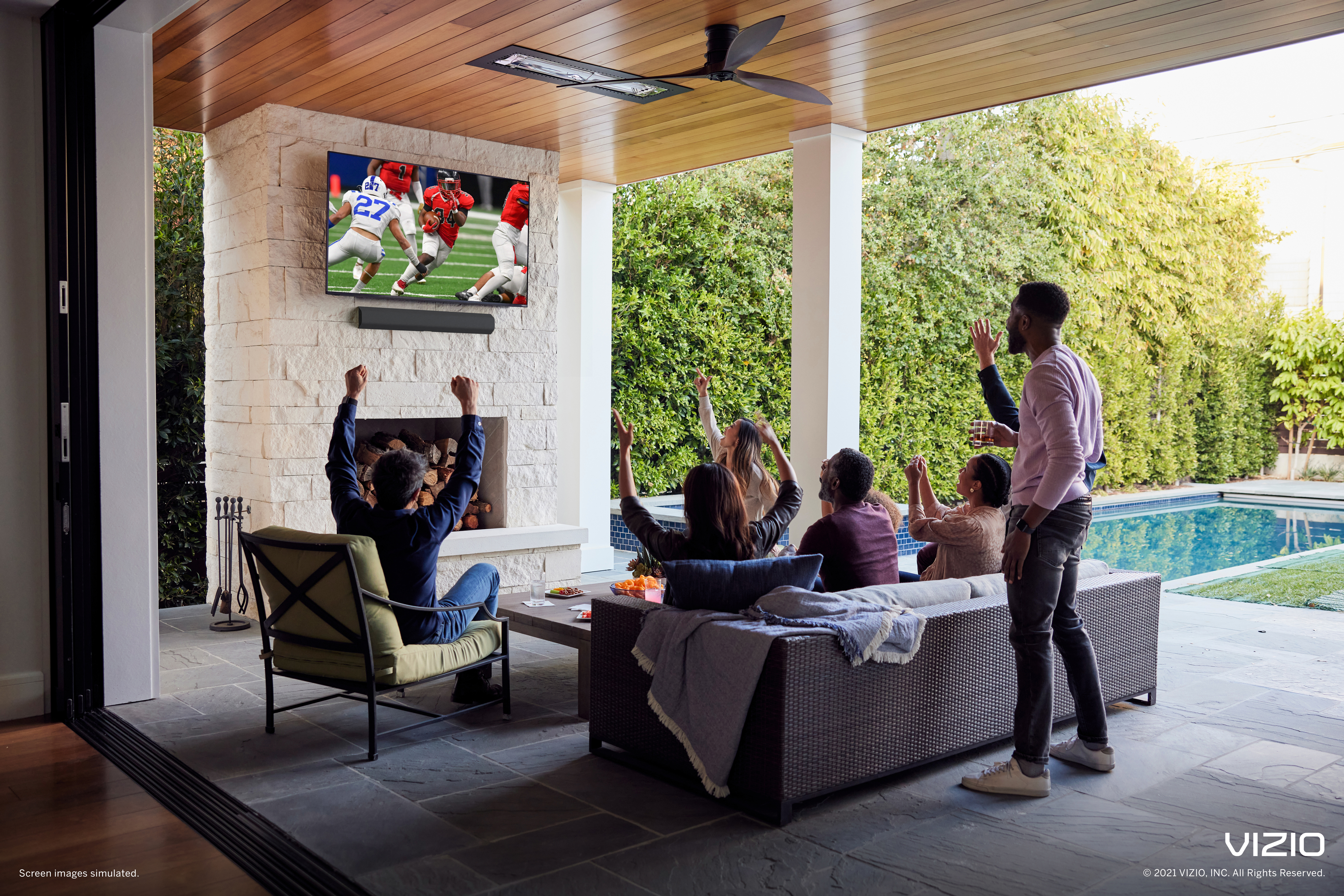 Small group of people watching Sling on a Vizio